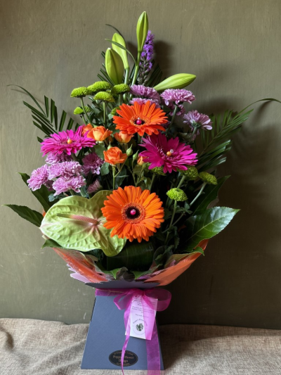 Poppy's Flower Design Florist in Leyland - Sugar Pop! - A stylish modern arrangement with cerise pinks, lime greens and bold oranges, prepared by our expert florists.
Florist in Leyland - Poppy's Flower Design