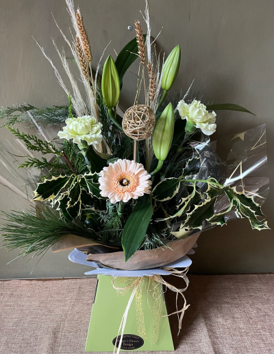 Winter Fresh - The Winter Fresh bouquet radiates crisp elegance with its soft, neutral tones and natural textures. Accented with seasonal foliage and rustic details, it evokes the serene beauty of a winter morning. Perfect for adding a touch of calm sophistication to any space.